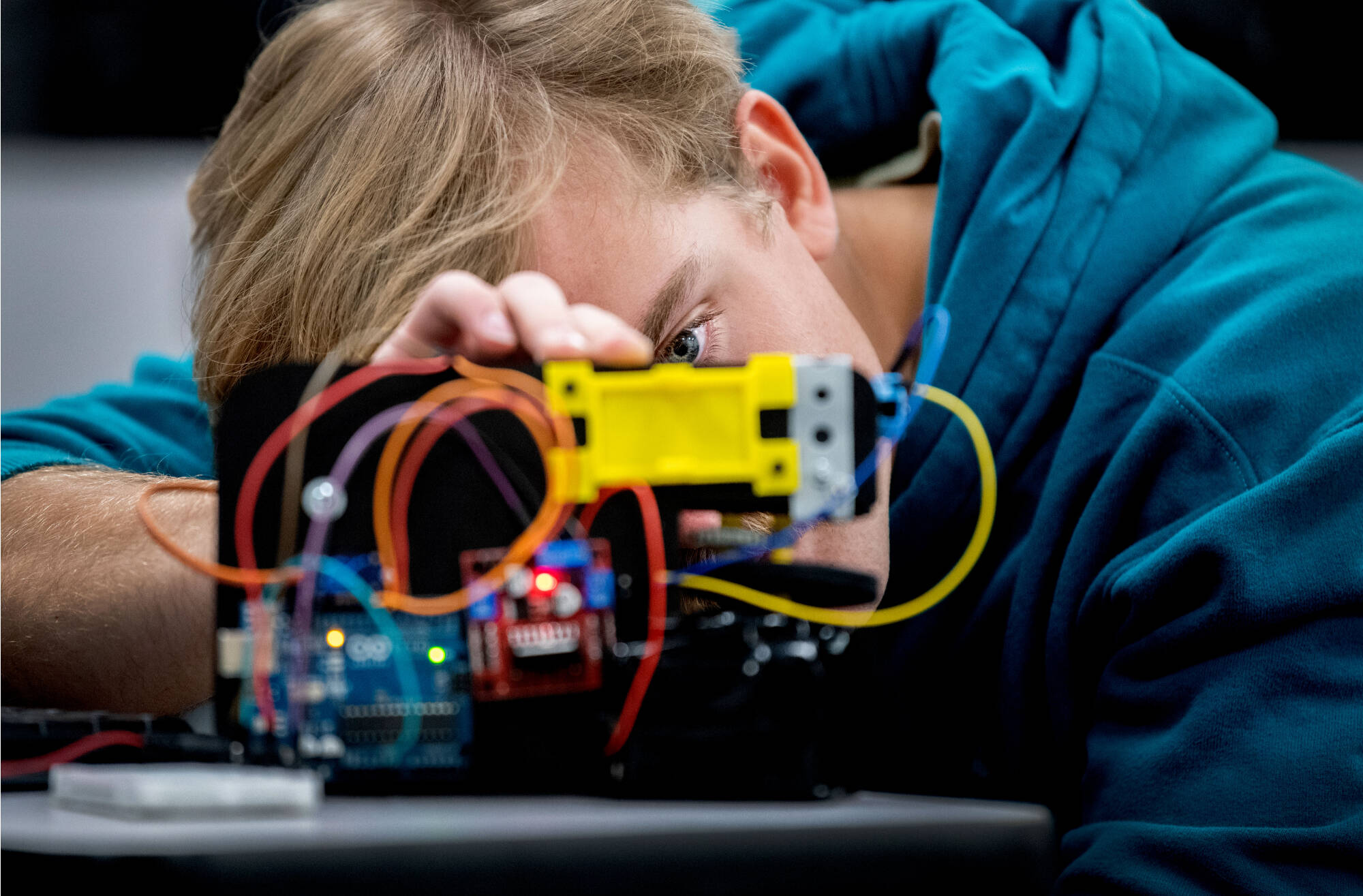 Engineering student messing with wires on an engineering project